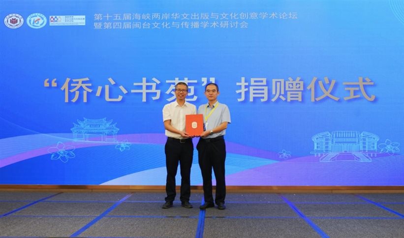 A couple of men holding a red folder&#xA;&#xA;AI-generated content may be incorrect.